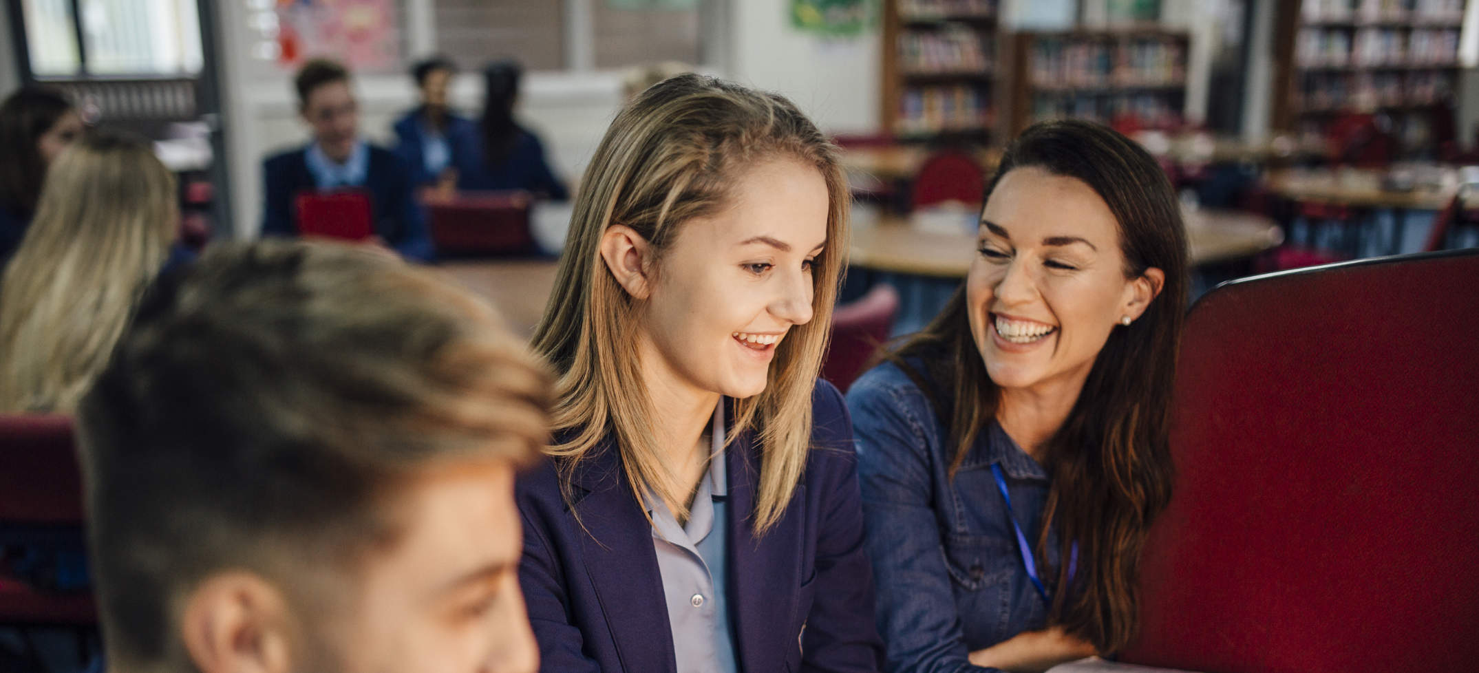 Student smiling while working with teacher